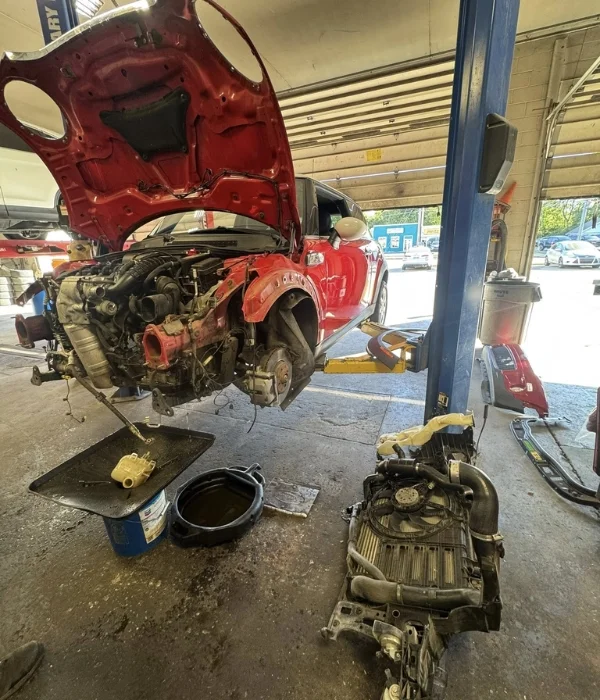 Compact car with the engine removed for service in Topeka