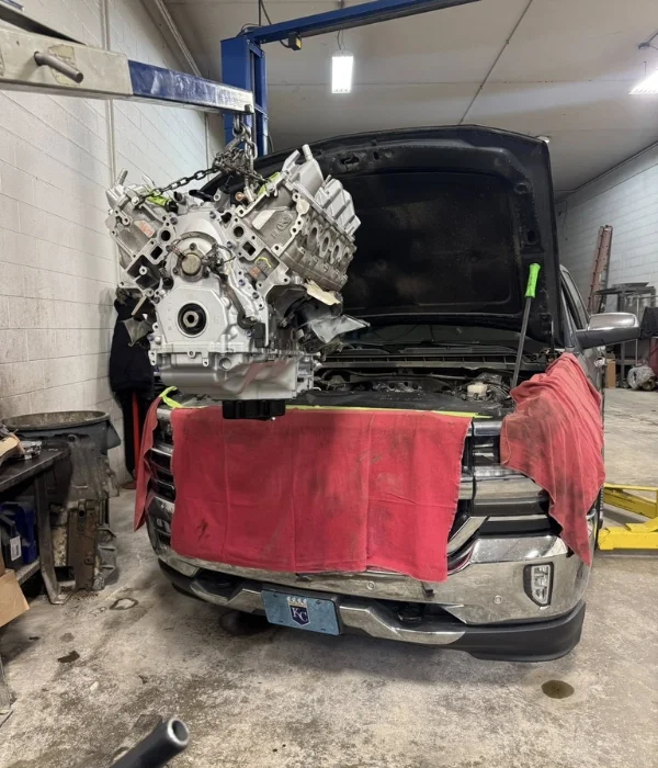 Truck engine on a hoist during a replacement in the Topeka shop